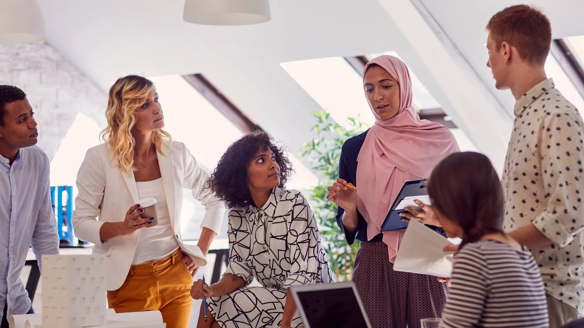 A diverse team of people are planning their annual workplace holiday activities.