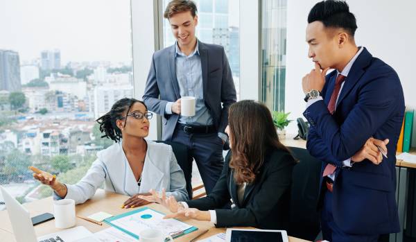 A diverse team of 4 people are reviewing their People team budget