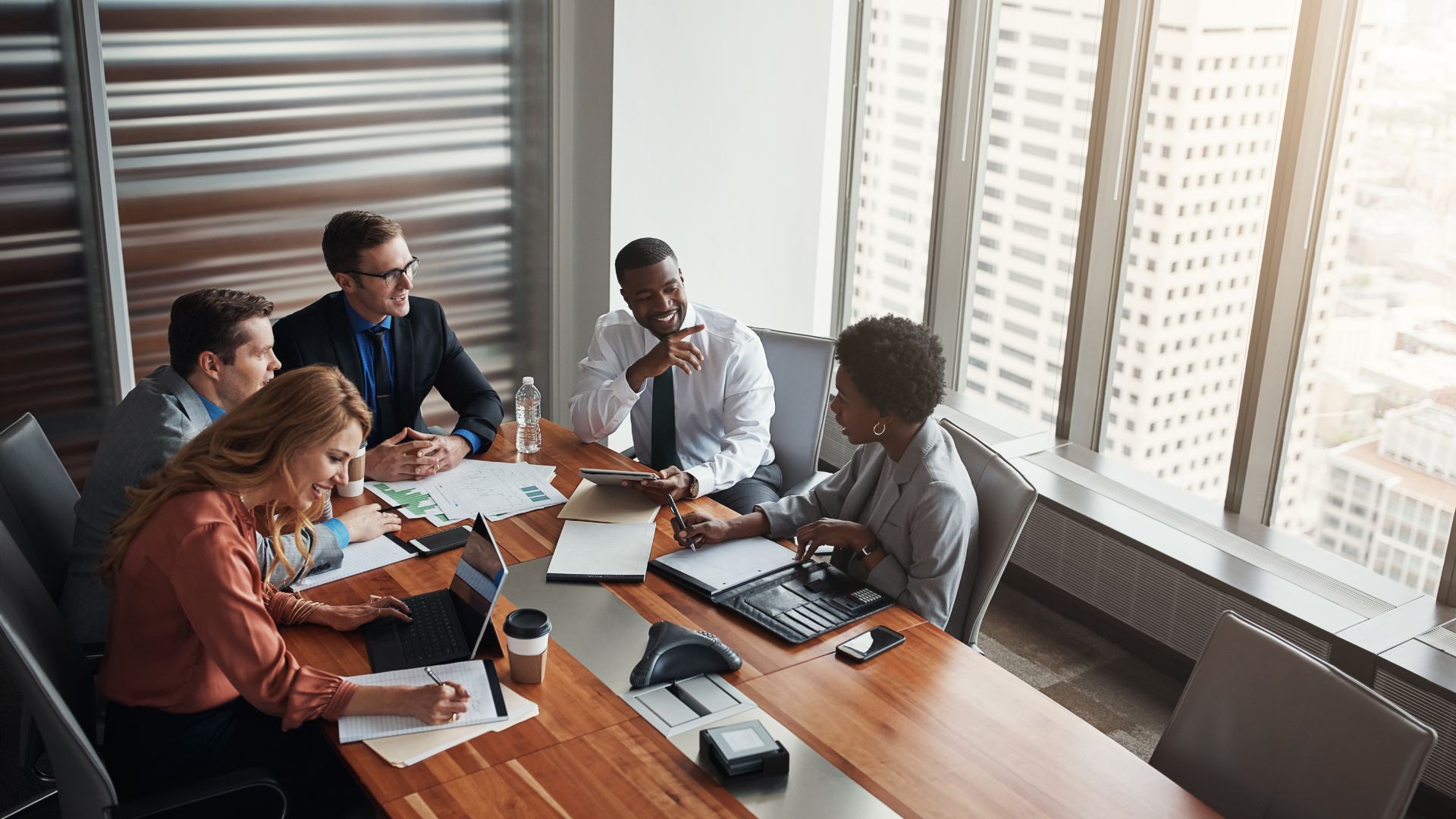 A diverse People team is gathered around a conference table doing strategic planning.