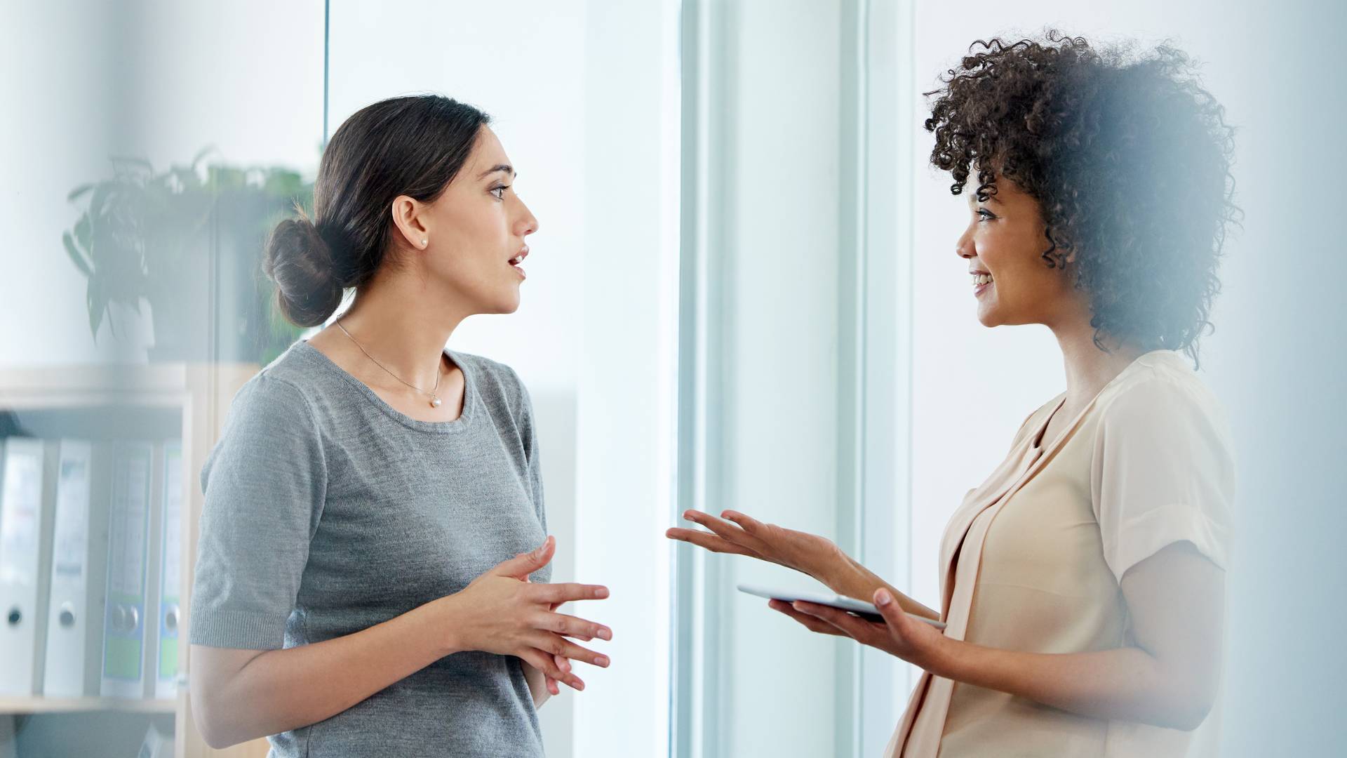 Two women are having an open and happy conversation.