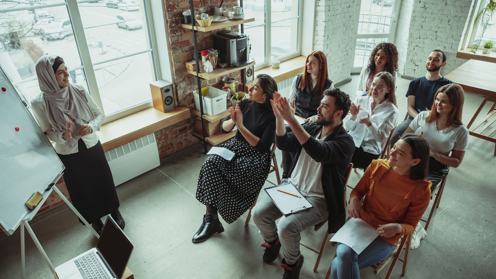 A diverse group of people are participating in high-performance culture training.