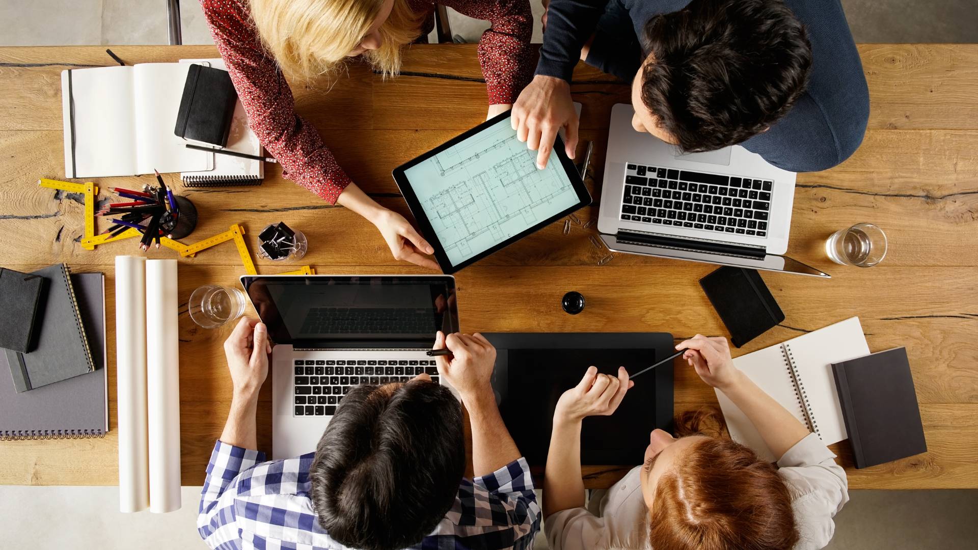 An overhead shot of a team collaborating on a project around a conference table.