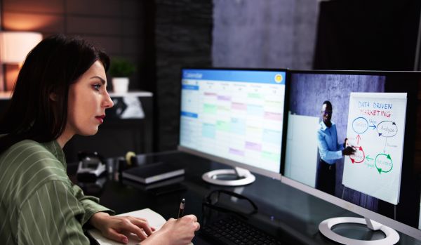 A woman is participating in a live, virtual training program.