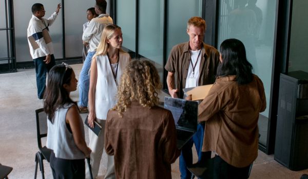 A group of people are participating in an experiential learning exercise in their office.
