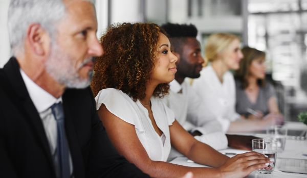 A diverse team of people are participating in a live training session.