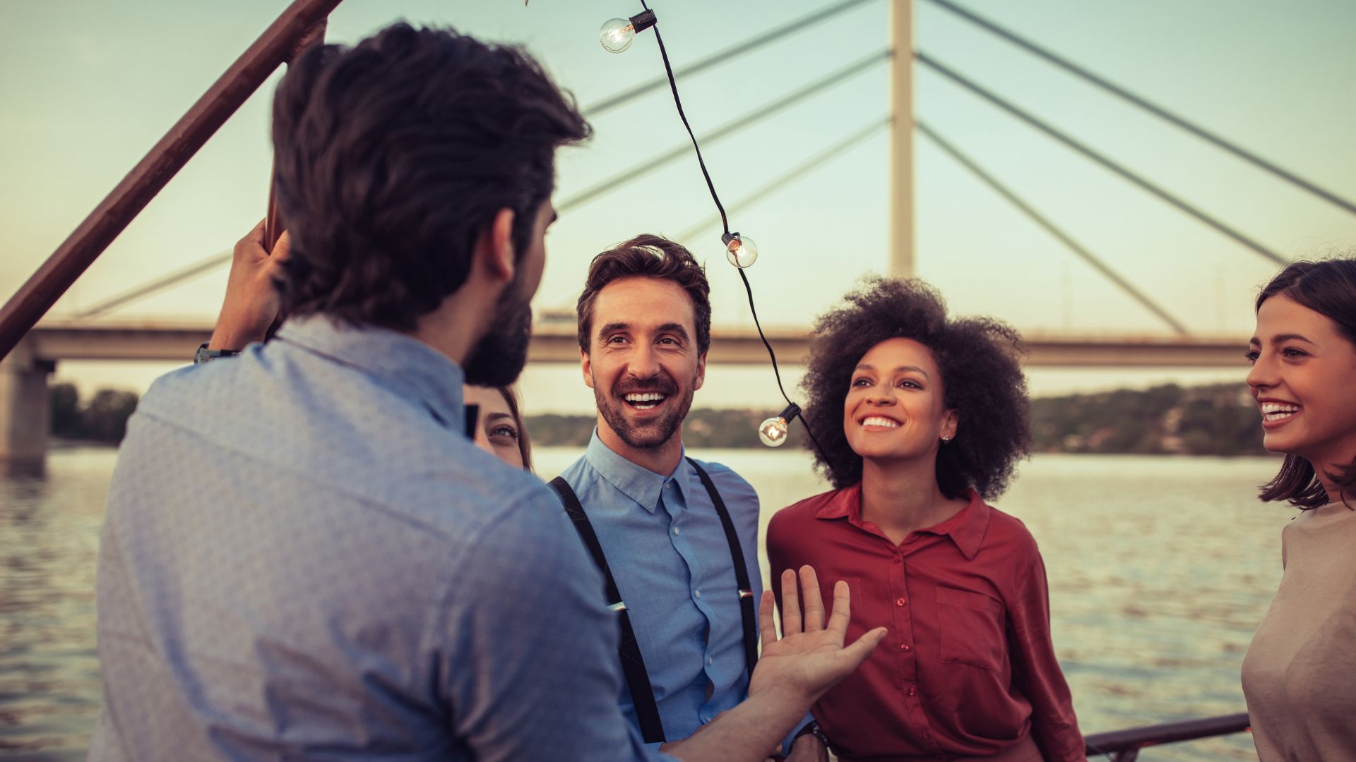 We're looking over a man's shoulder as he tells his friends a story.