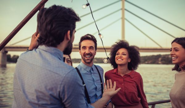 We're looking over a man's shoulder as he tells his friends a story.