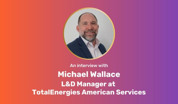 A centered, circular photo of Michael Wallace on an orange-purple gradient rectangle with white bold text underneath: "An interview with Michael Wallace L&D Manager at TotalEnergies American Services"
