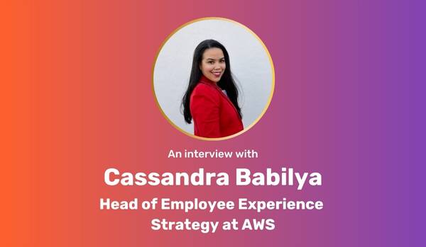 Orange-purple gradient rectangle with circle photo of Cassandra Babilya with "an interview with Cassandra Babilya, Head of Employee Experience Strategy at AWS" underneath in bold white text.