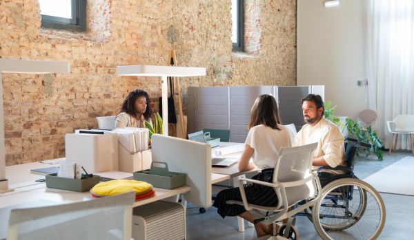 A team of people are working in an open concept office.