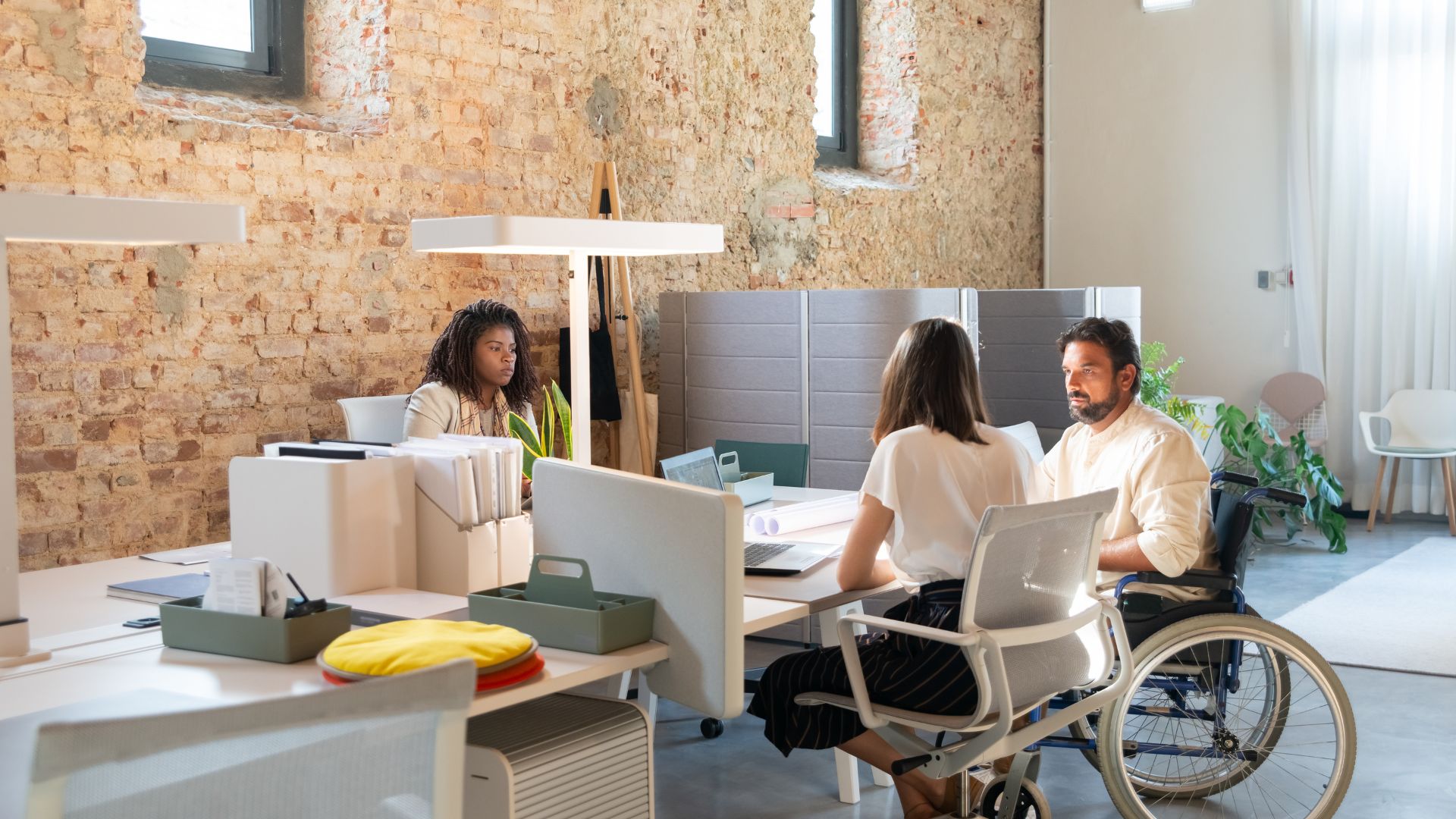 A team of people are working in an open concept office.