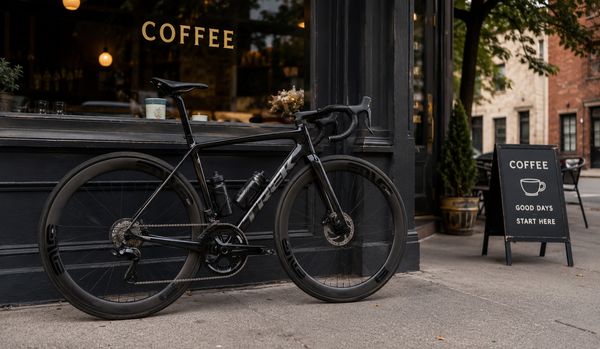 A fancy road bicycle parked outside a coffee shop