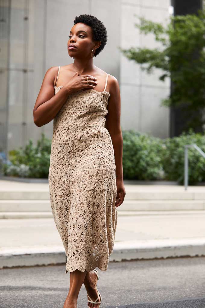 Model wearing a cream-colored Donna Karan lace midi dress. Image courtesy of Plural, NYC - Social Media Marketing and Content Production Studio.