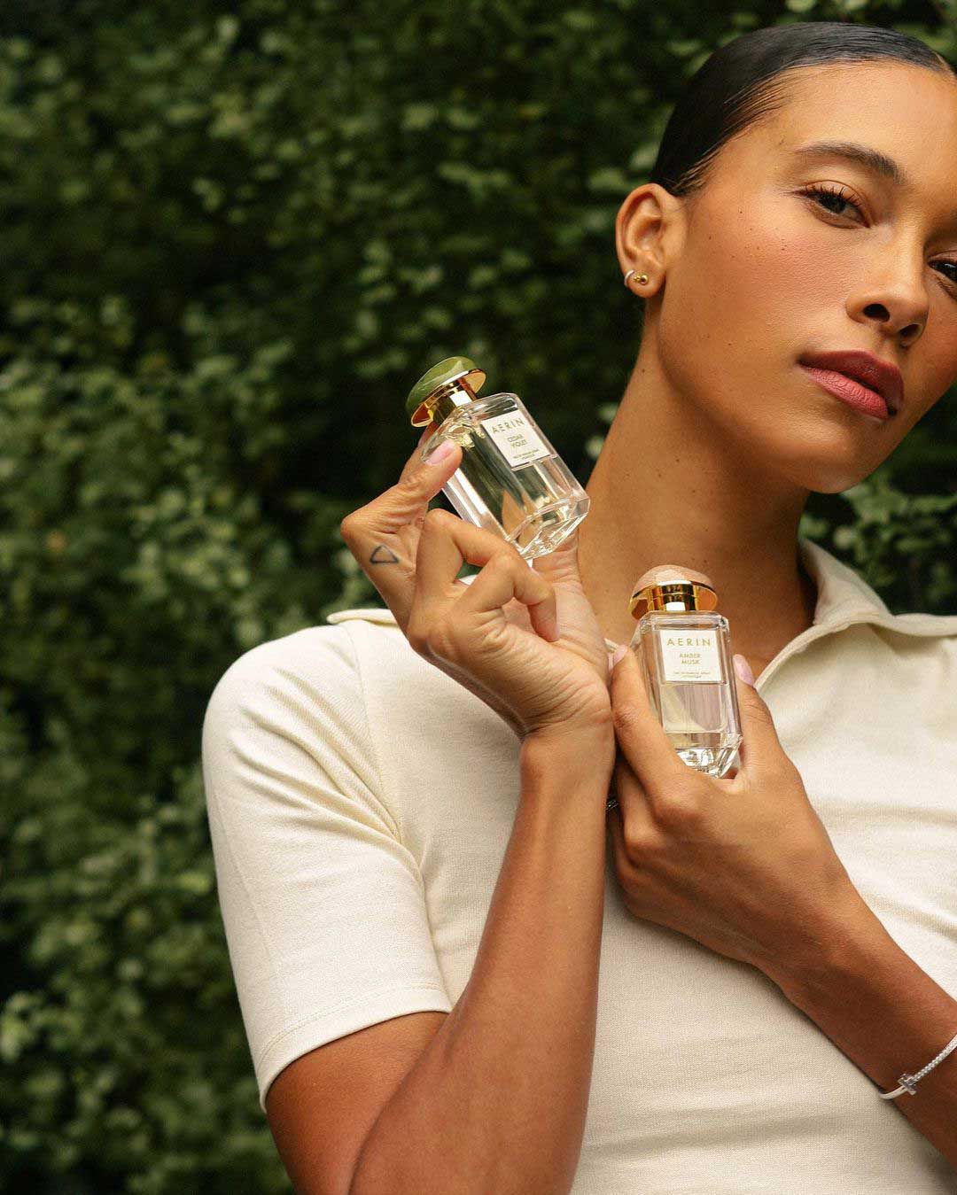 Influencer smelling a vase of roses. Brought to you by Plural, NYC: Experts in Social Media Marketing Strategy and High-Quality Content Production.