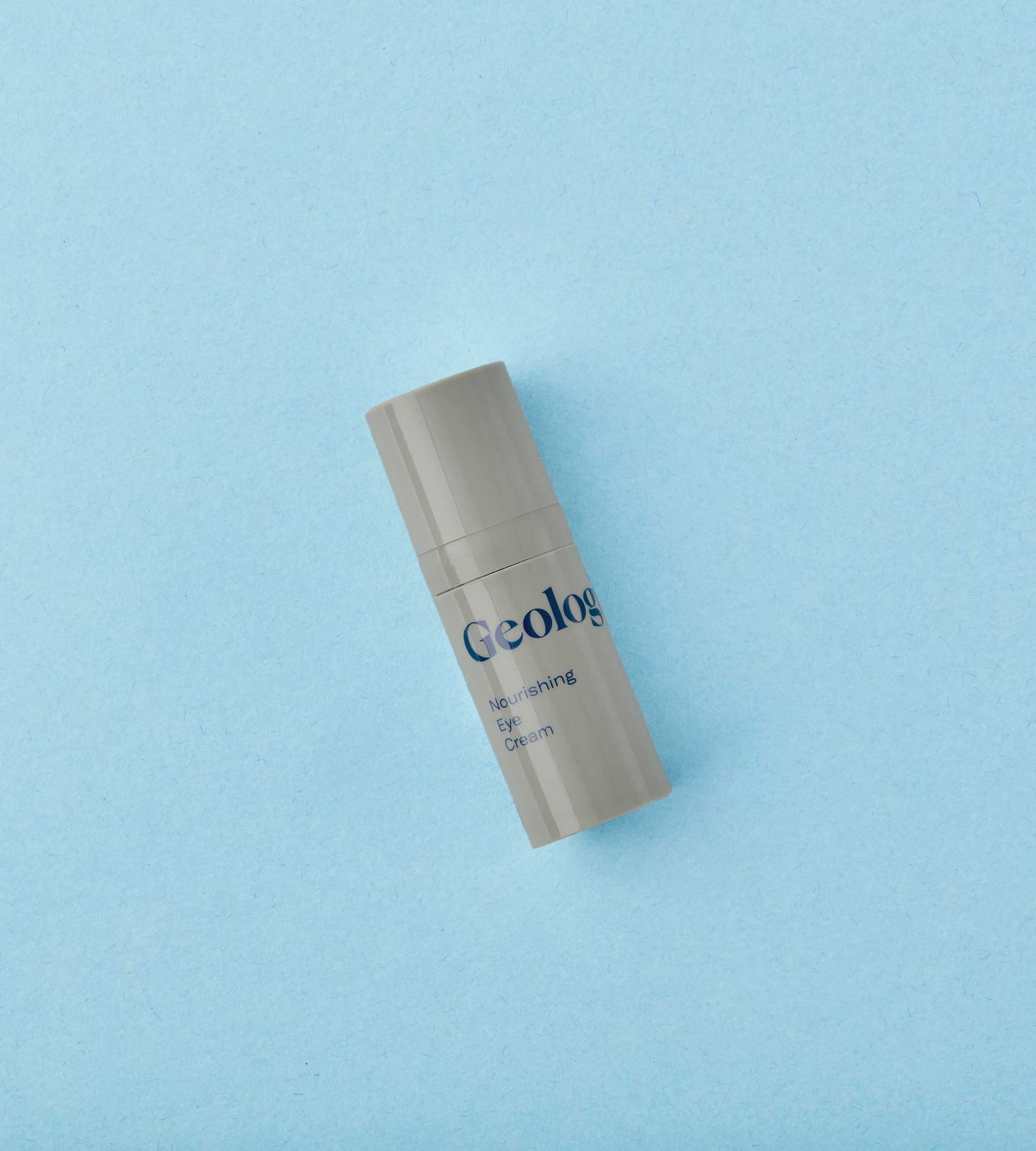 Geologie eye cream bottle on a blue background. Brought to you by Plural, NYC: Experts in Social Media Marketing Strategy and High-Quality Content Production.
