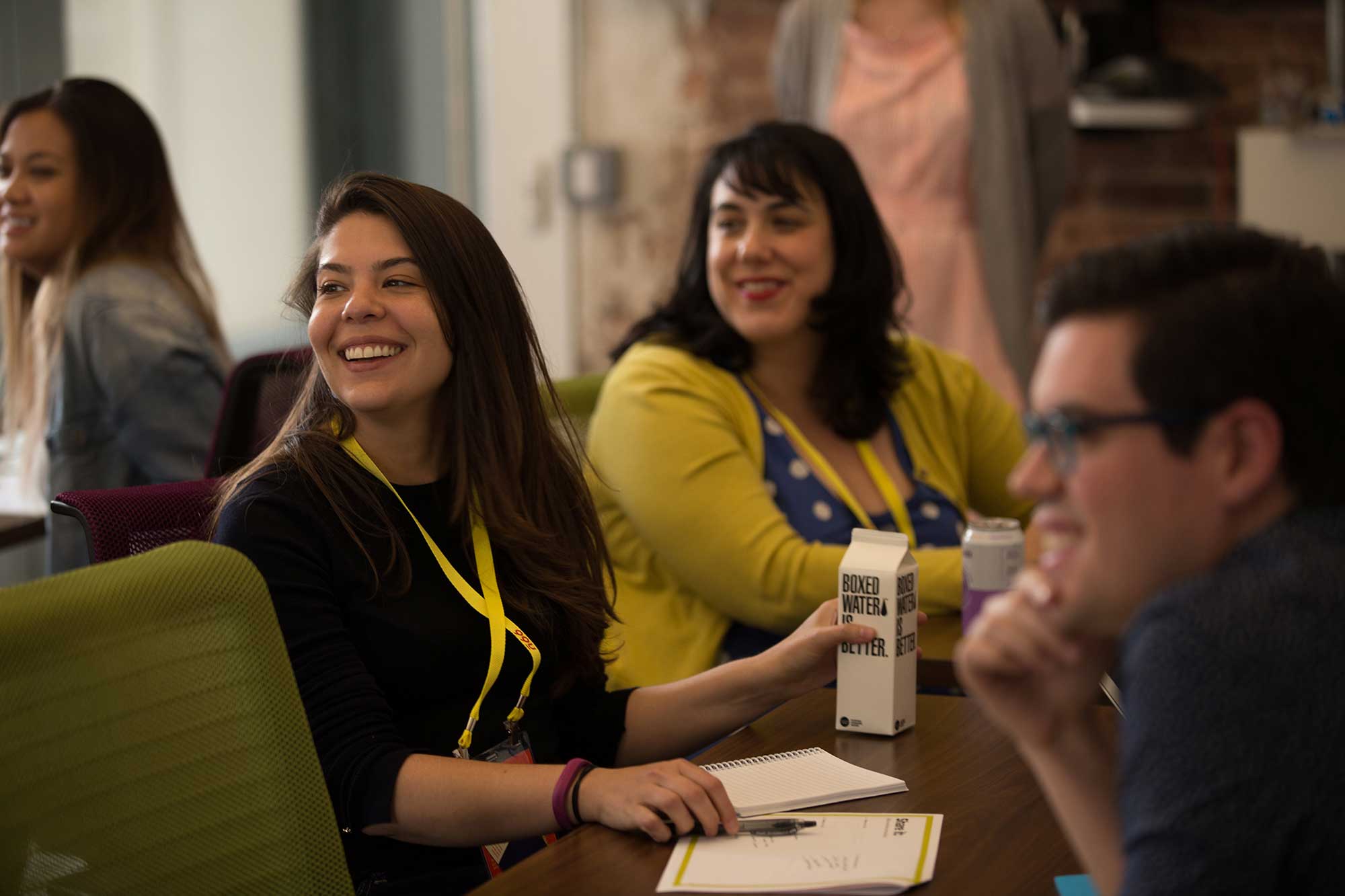 People in conversation at a conference table at the Adobe 99U Conference. Brought to you by Plural, NYC: Experts in Social Media Marketing Strategy and High-Quality Content Production.