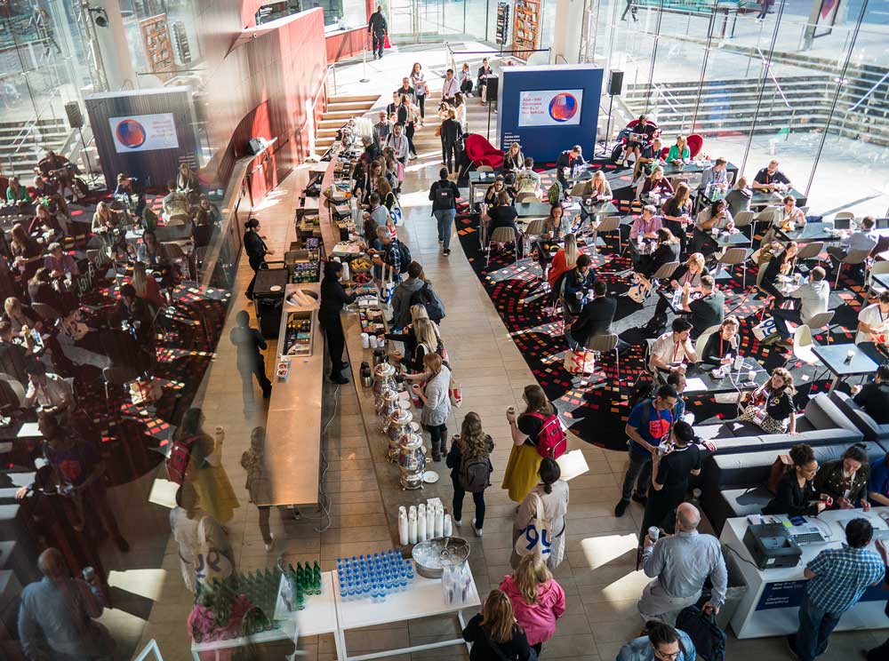 Adobe 99U Conference attendees enjoying refreshments at an event buffet. Image from Plural, NYC - Social Media Marketing & Content.