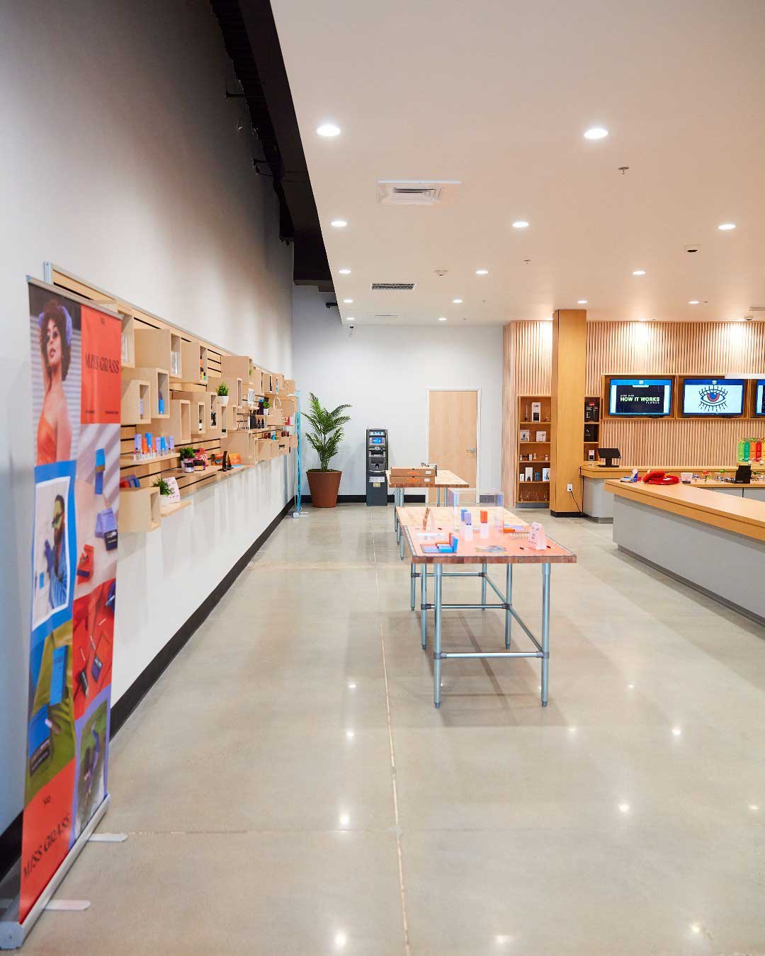 Aunt Mary's dispensary with product displays, tables, and a counter. Brought to you by Plural, NYC: Experts in Social Media Marketing Strategy and High-Quality Content Production.