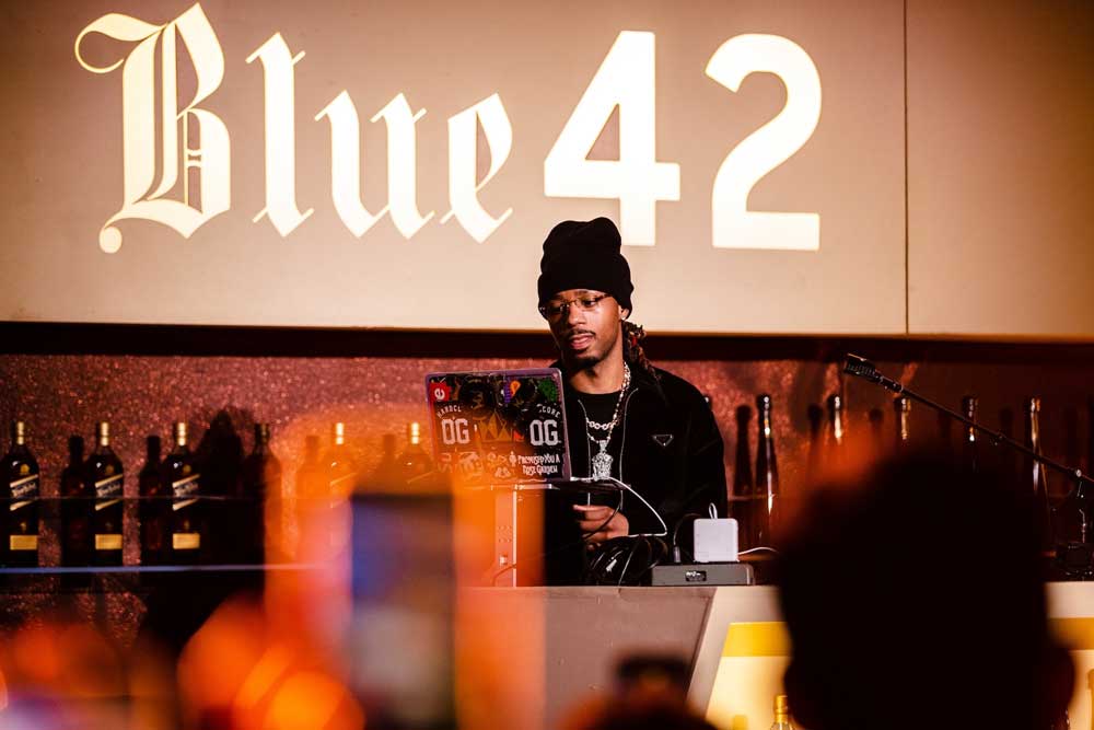 DJ on stage at a "Blue 42" event by Johnnie Walker and Don Julio. Brought to you by Plural, NYC: Experts in Social Media Marketing Strategy and High-Quality Content Production.