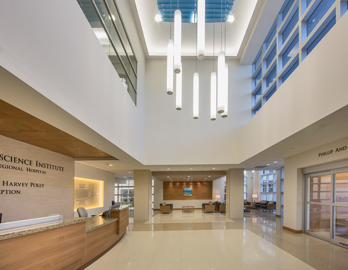 Suspended cylindrical lights in the double-height hospital atrium.