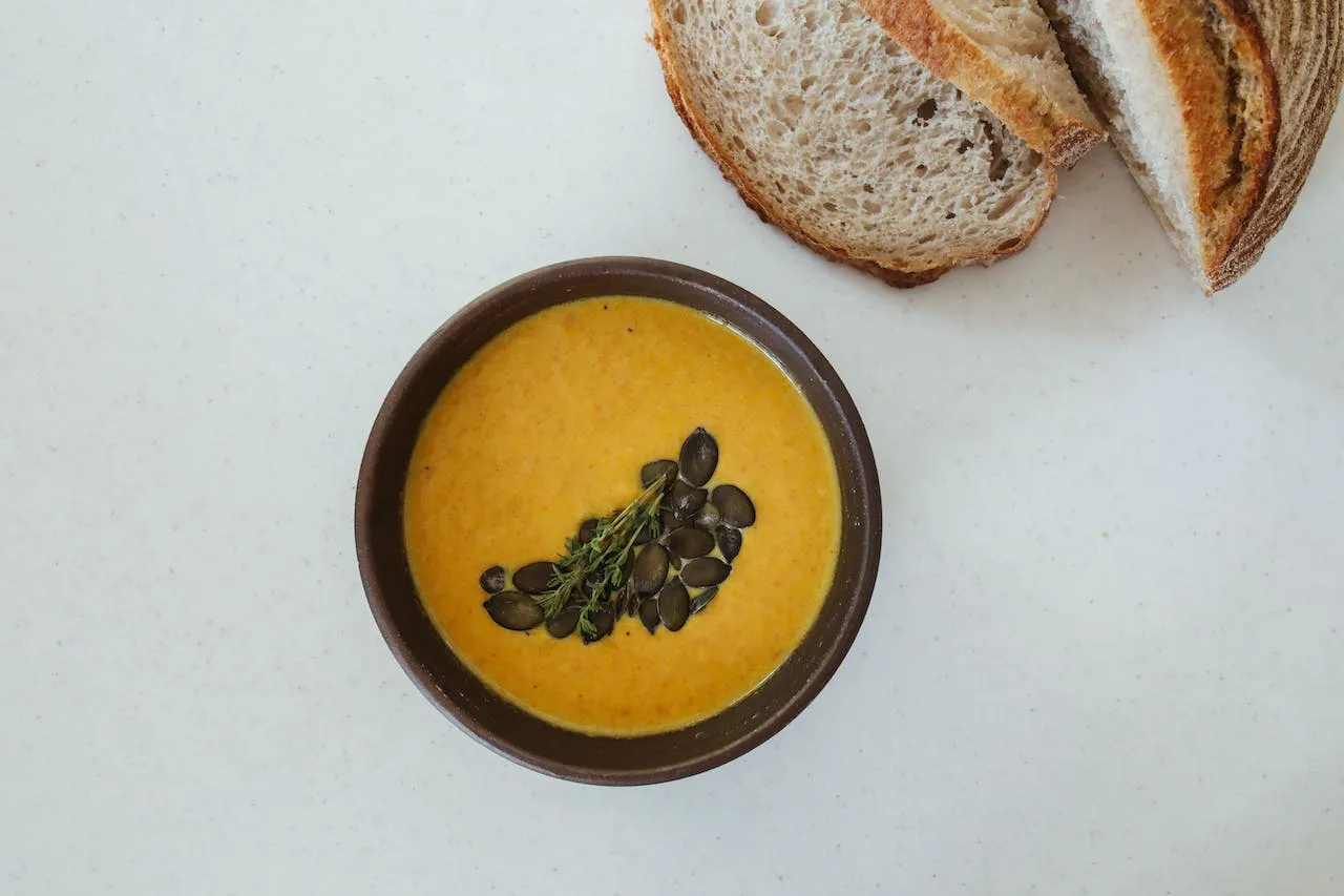pumpkin-soup-in-a-bowl-beside-the-bread