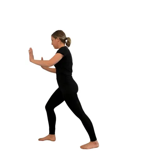 woman in black doing a calf stretch.