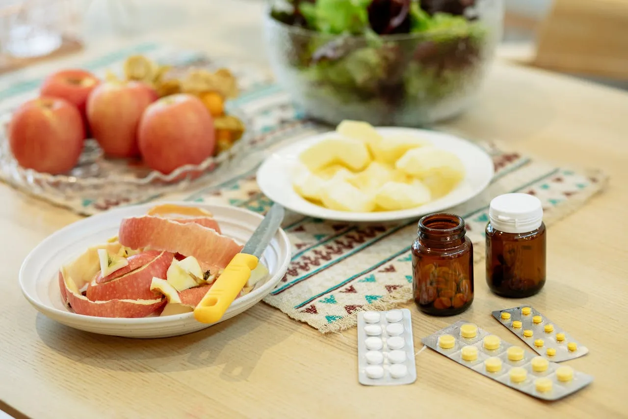 Fruits, vegetables, and supplements on a kitchen table