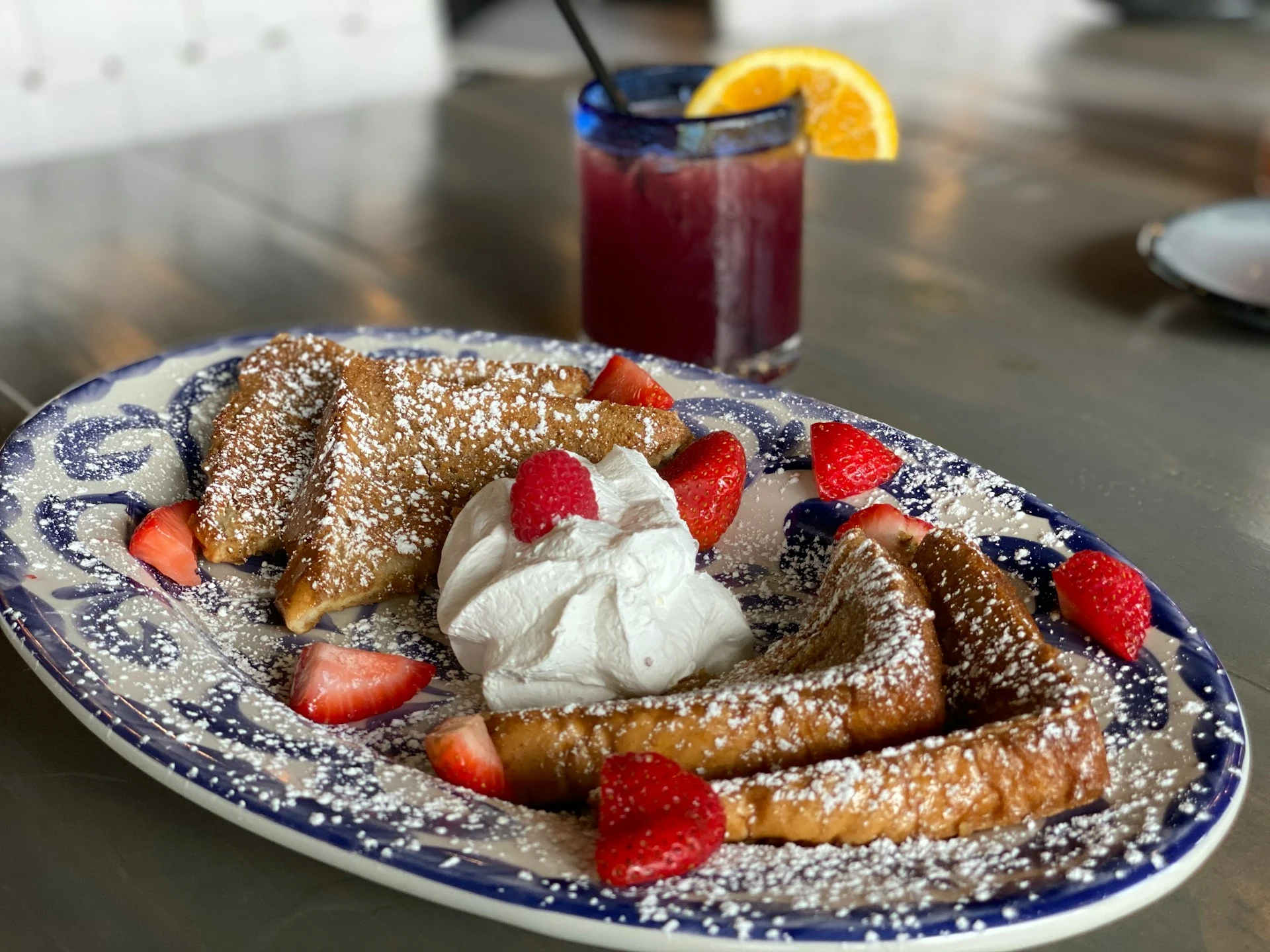 A plate with french toast and cream