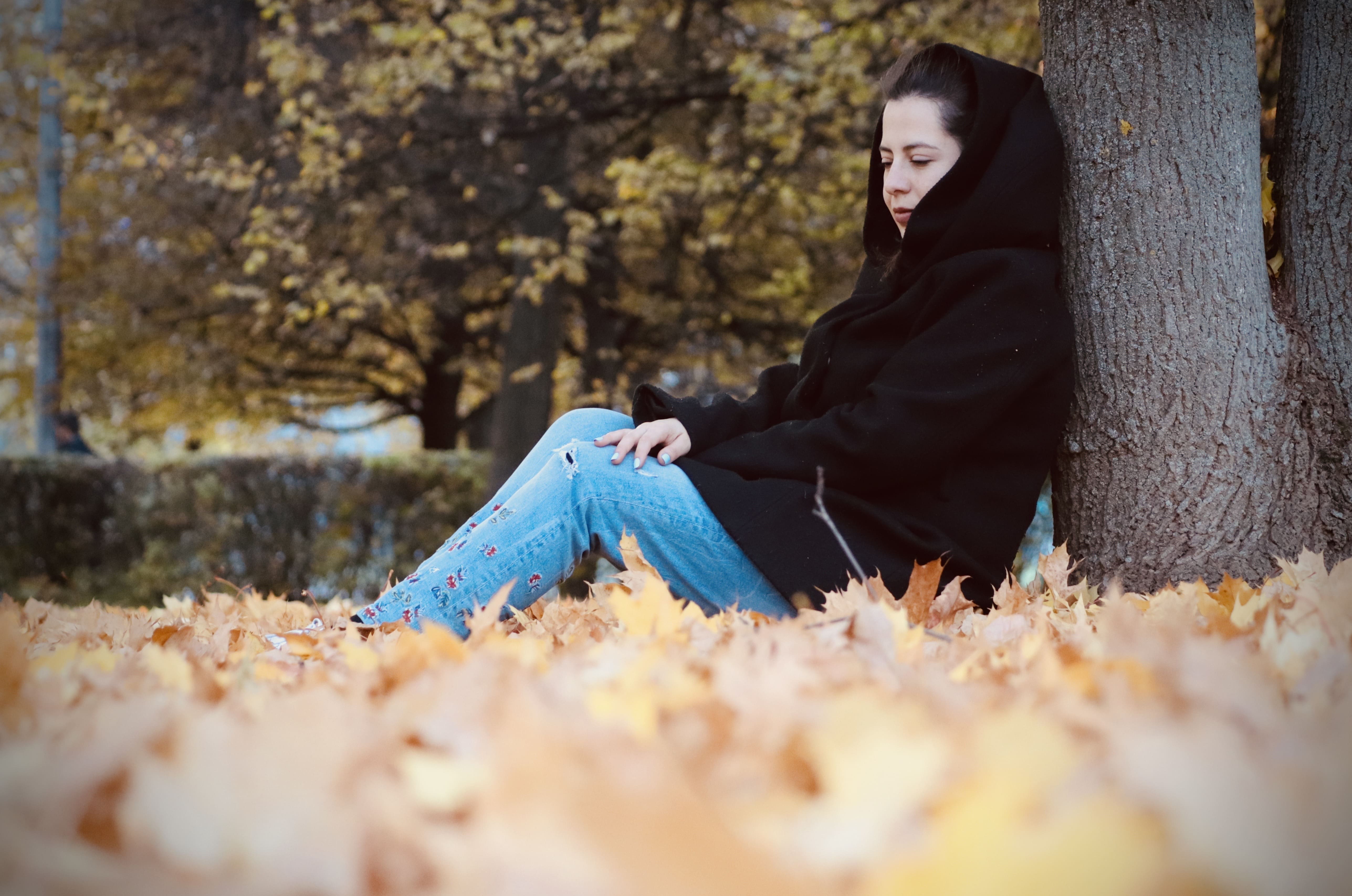 girl sitting by leaves