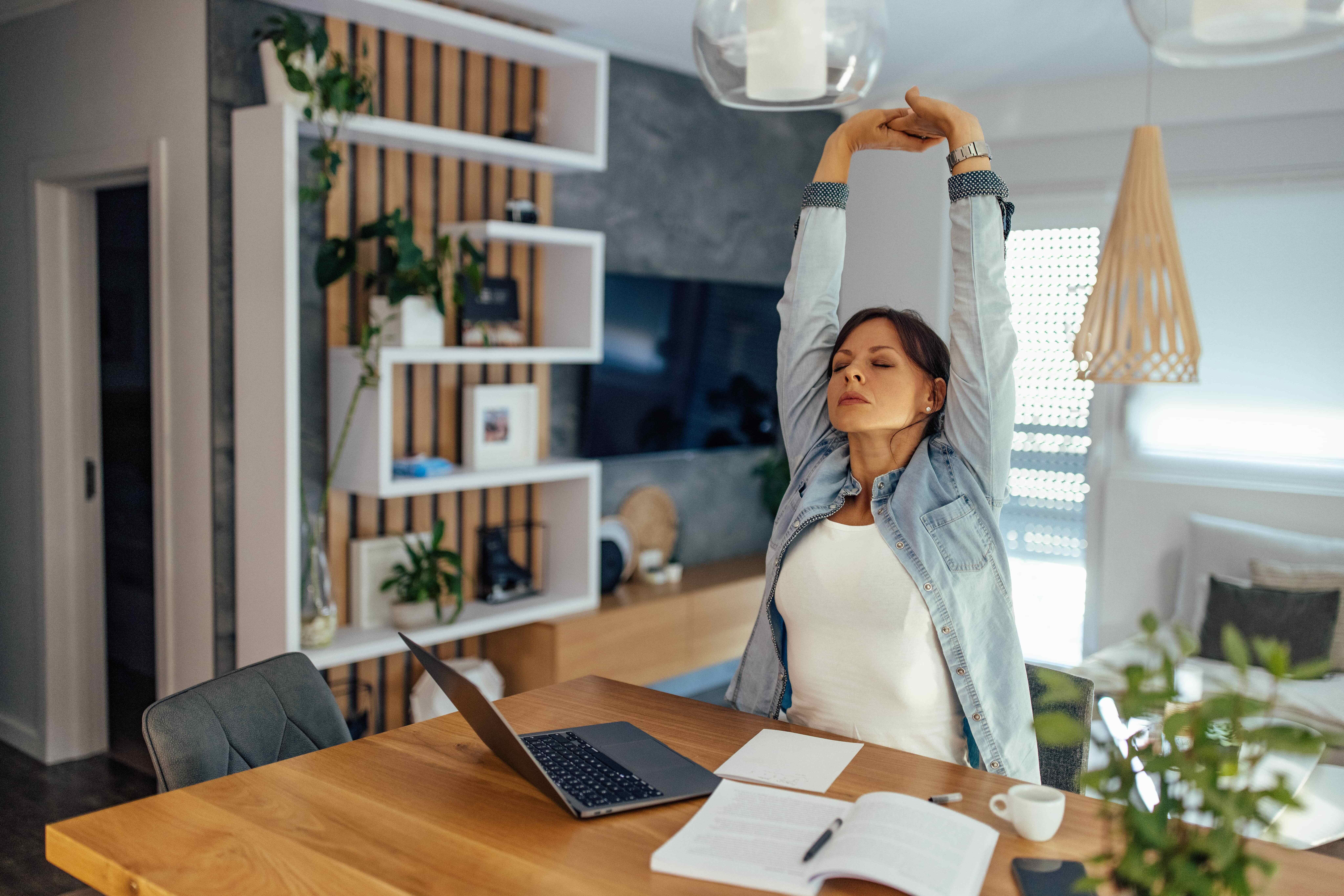 woman stretching at desk