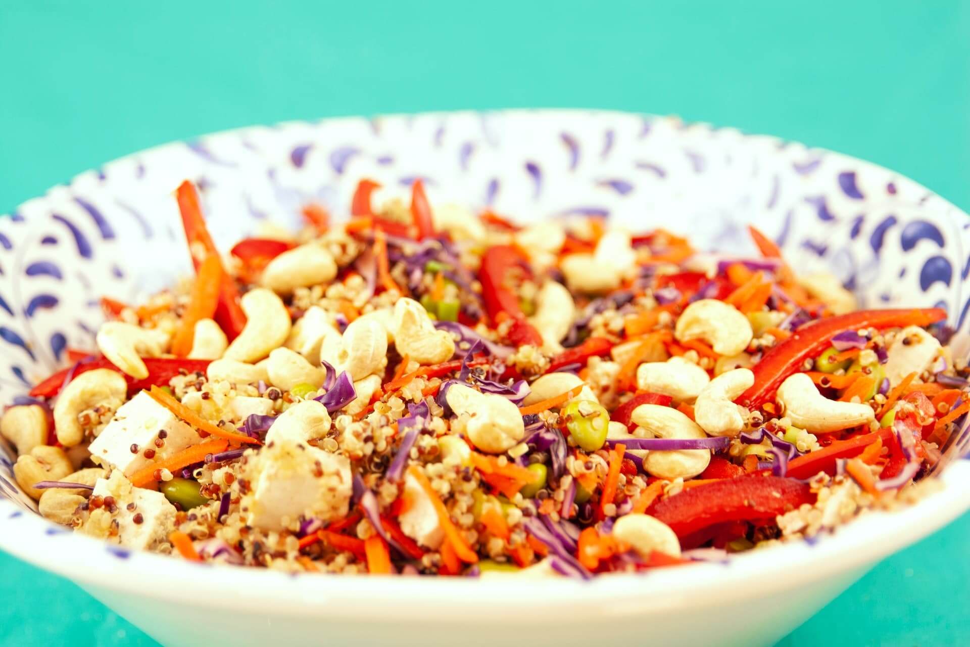Colorful quinoa salad with carrots, cashews, and purple cabbage