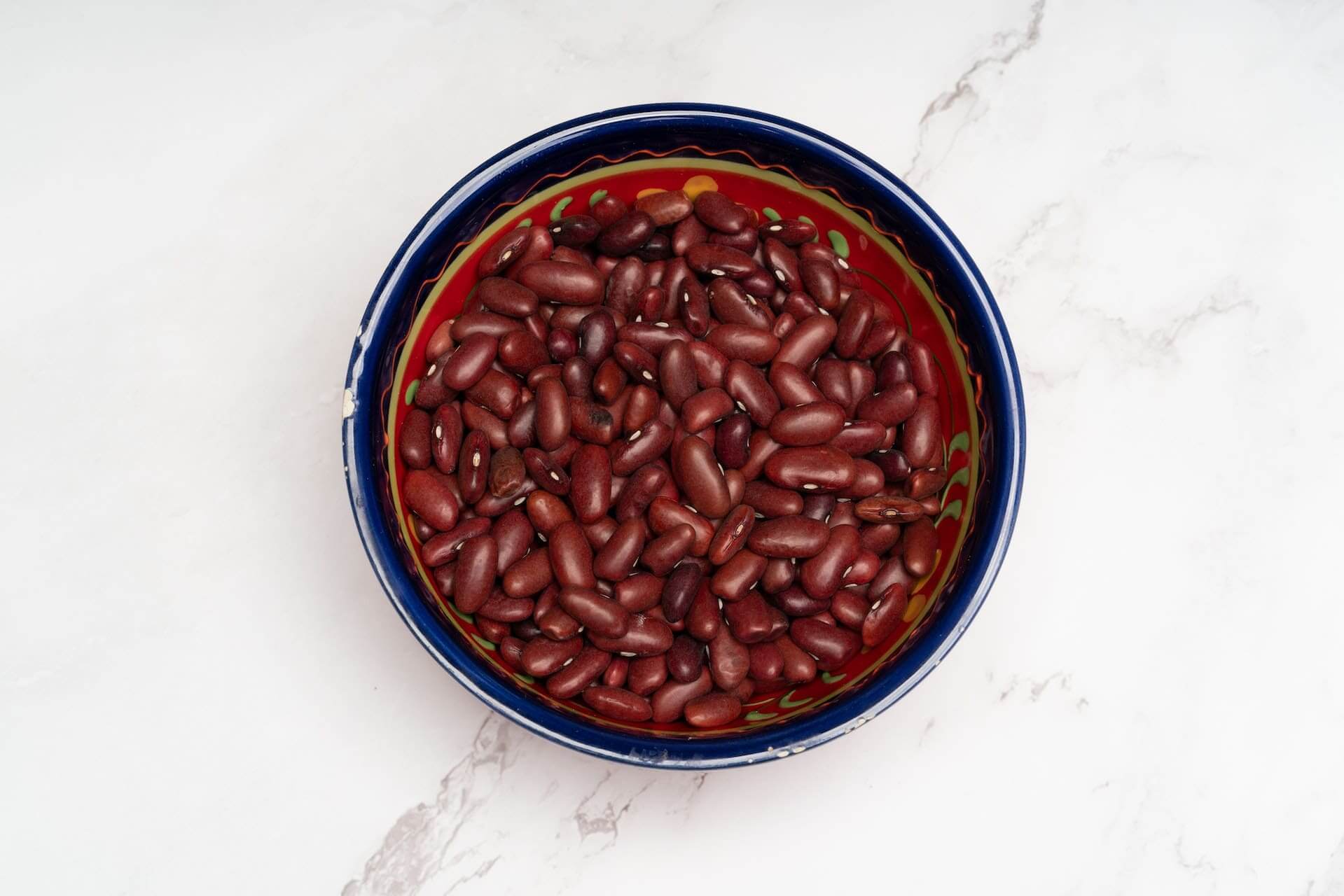 Red kidney beans in a colorful decorative ceramic bowl