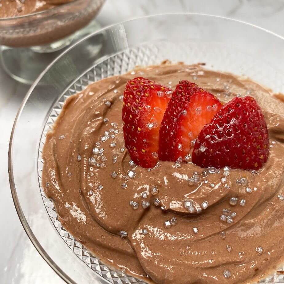 Chocolate mousse topped with fresh strawberries and silver sprinkles