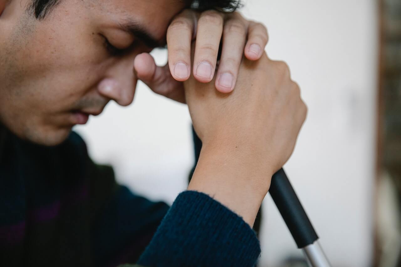 Person with closed eyes praying or experiencing emotional moment