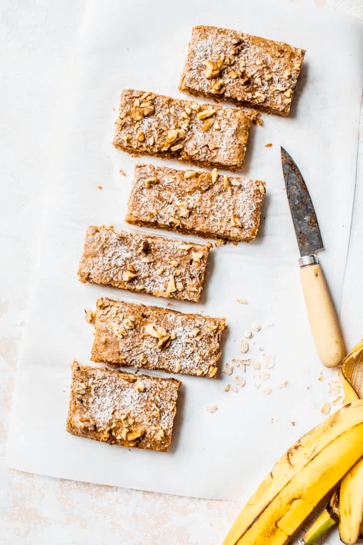 Homemade banana bars with nuts, dusted with powdered sugar