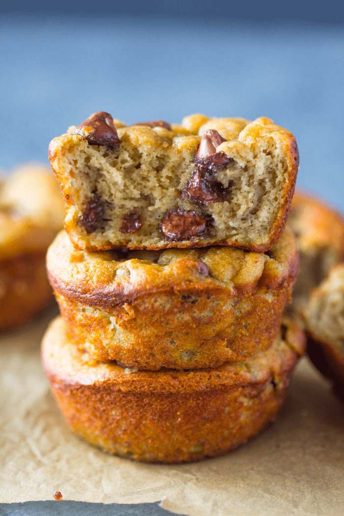Stacked chocolate chip banana muffins with soft, moist interior