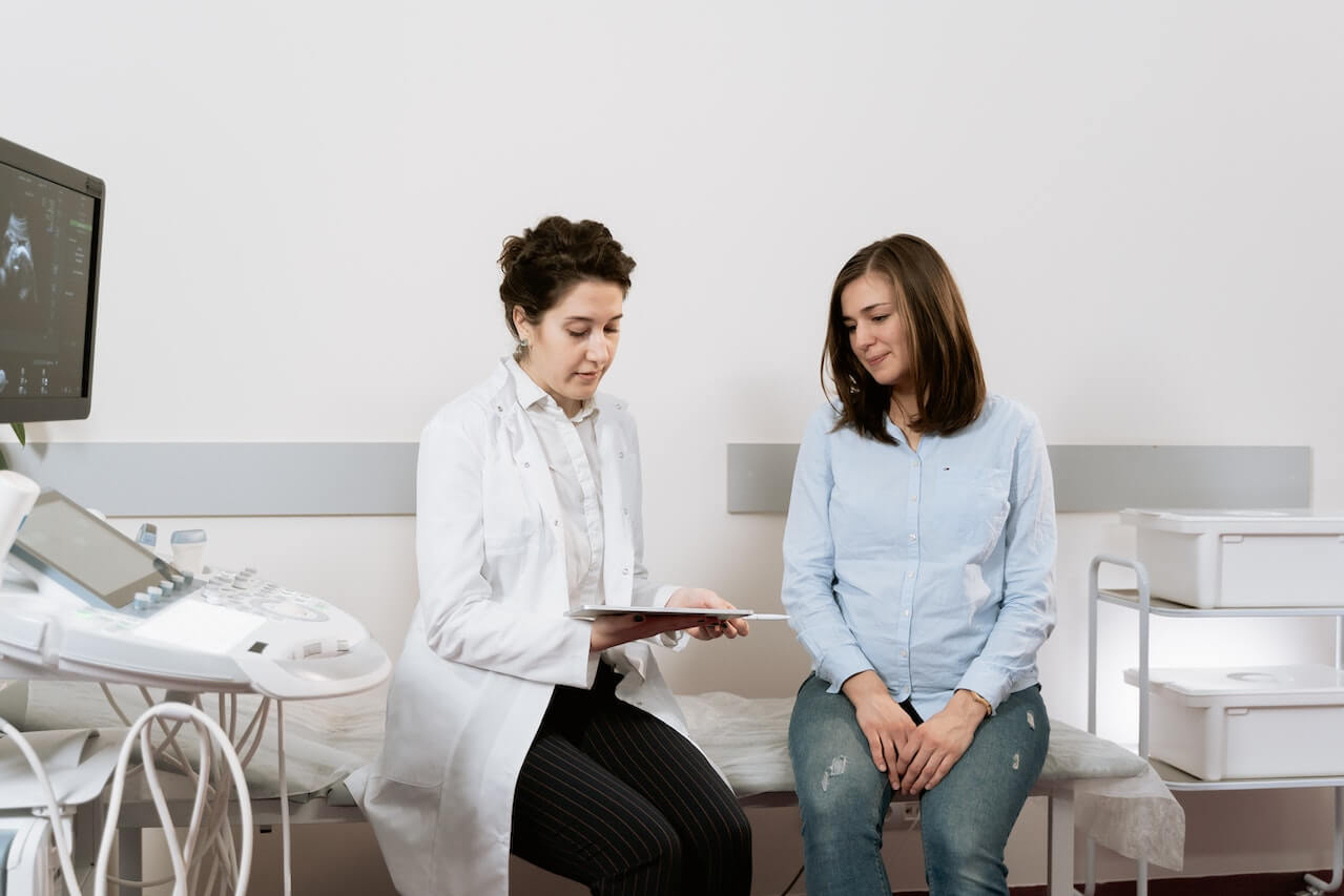 Doctor discussing medical results with patient in clinical examination room