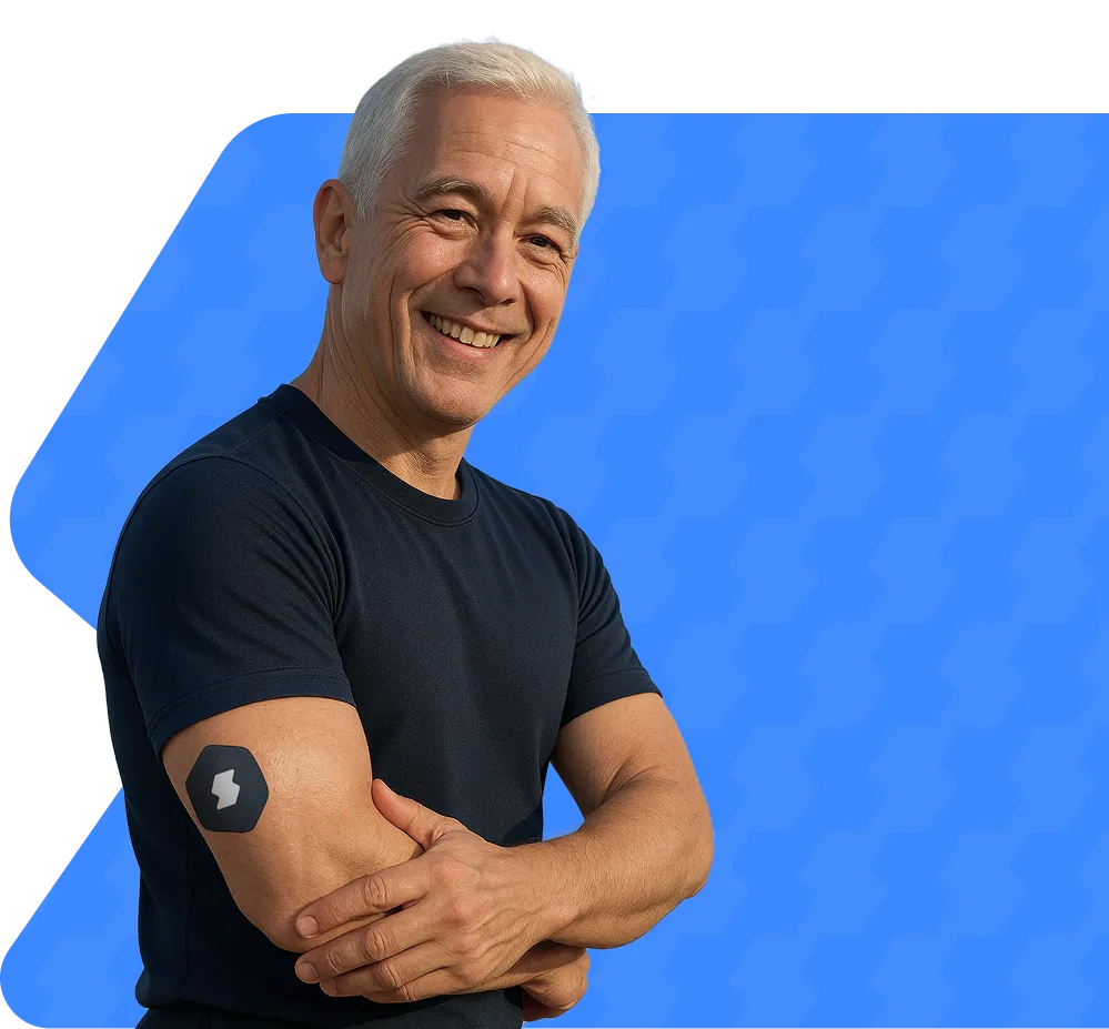 Smiling older man in black shirt against blue background with crossed arms