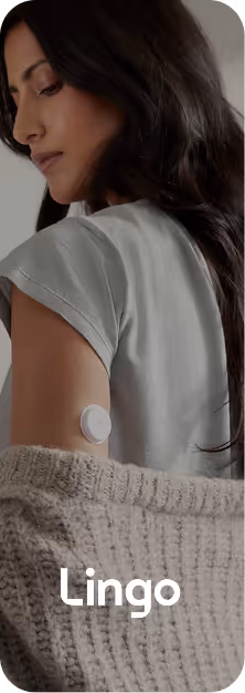 Woman wearing continuous glucose monitor patch on back