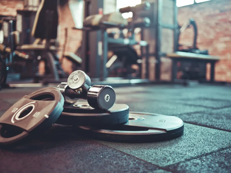 Gym equipment financing for dumbbells and weight plates in modern fitness facility