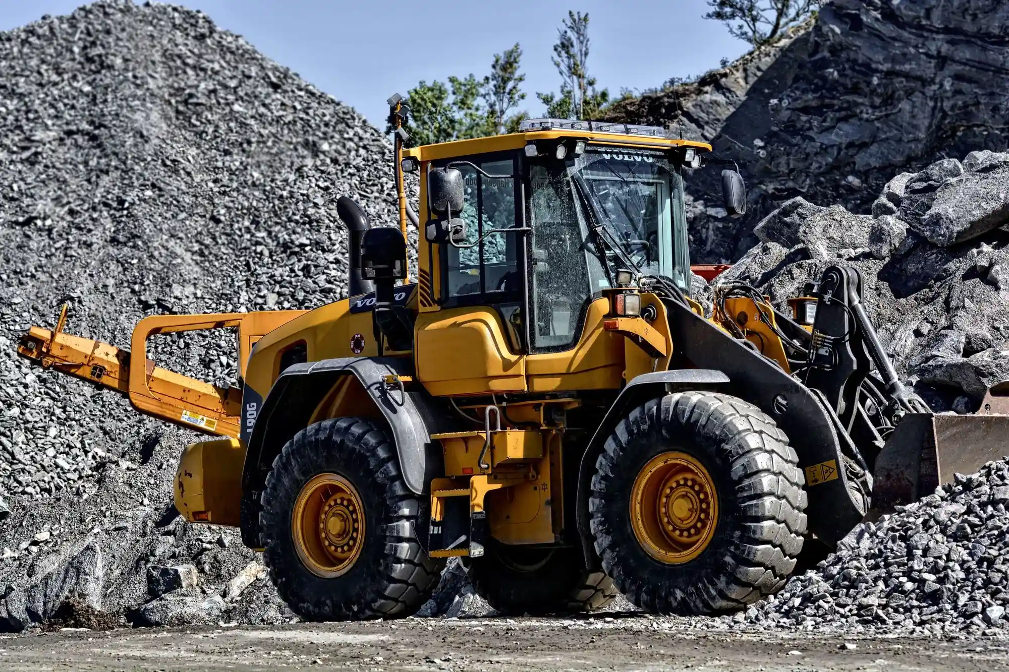 Yellow Volvo wheel loader operating at a construction site, representing heavy equipment available through leasing programs