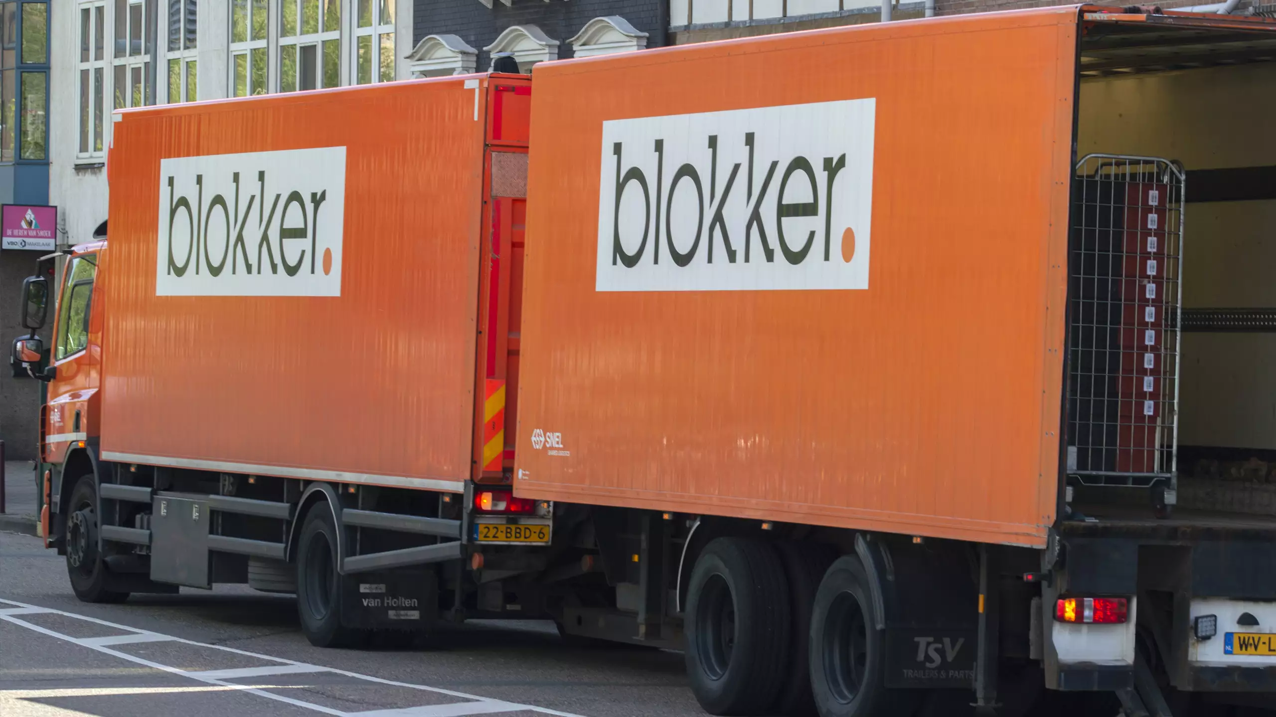 The image shows a blokker delivery truck bringing household essentials to the customer's doorstep.