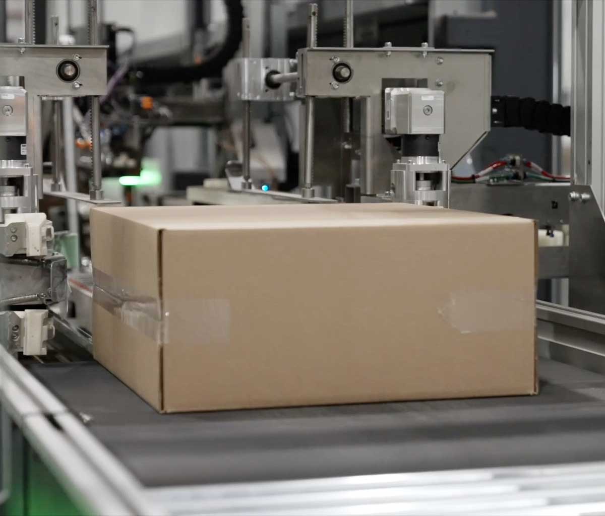 A photo of an item getting packaged in an automated packaging machine