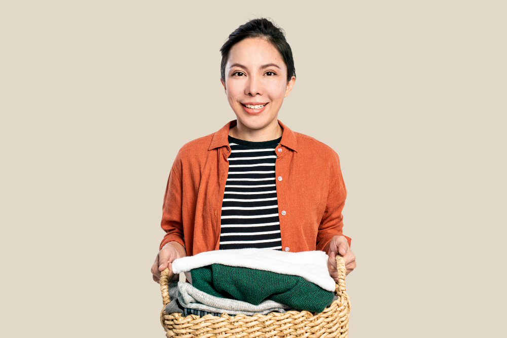 Woman holding a basket of freshly laundered clothes