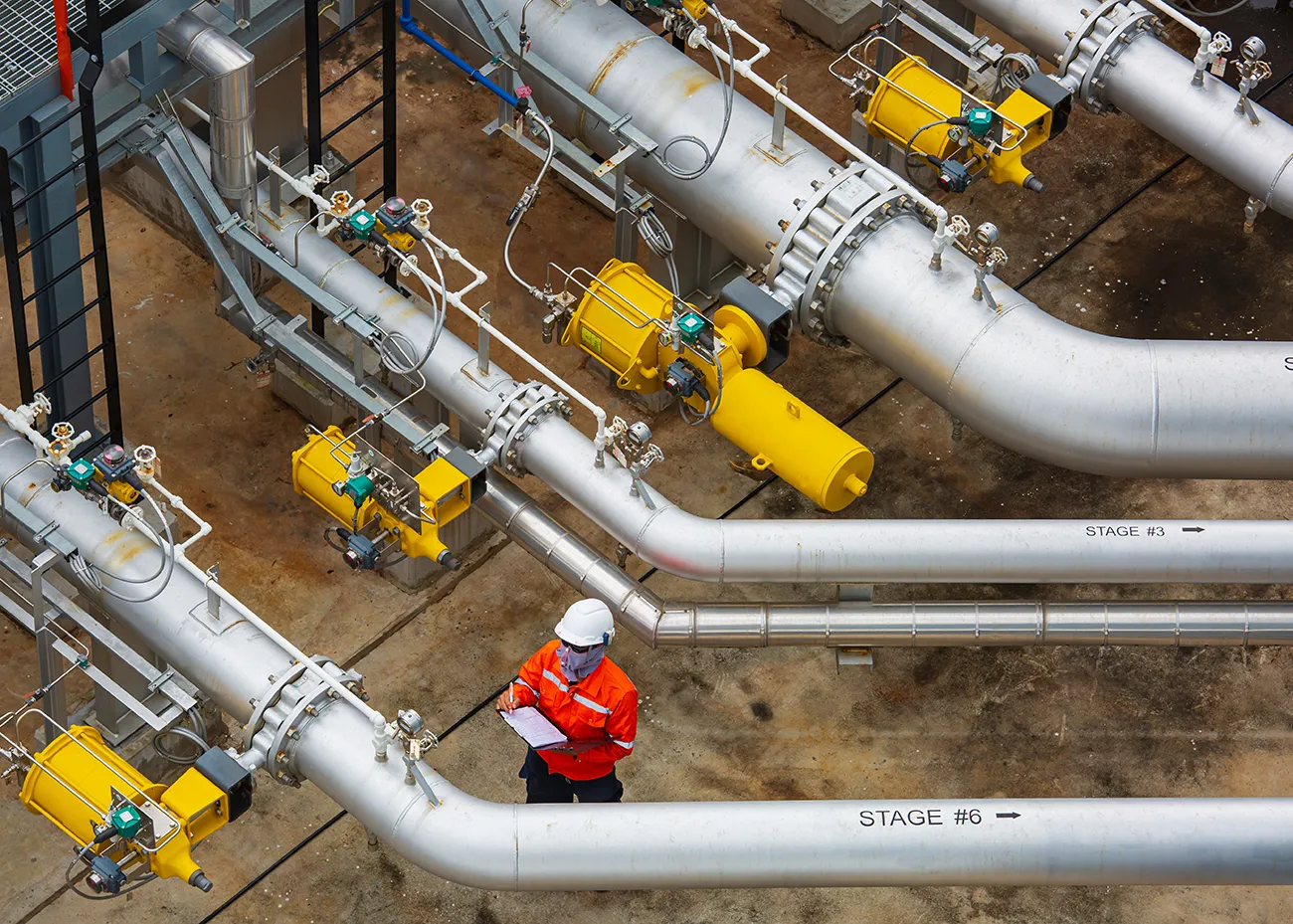 An inspector inspects a pipeline facility.