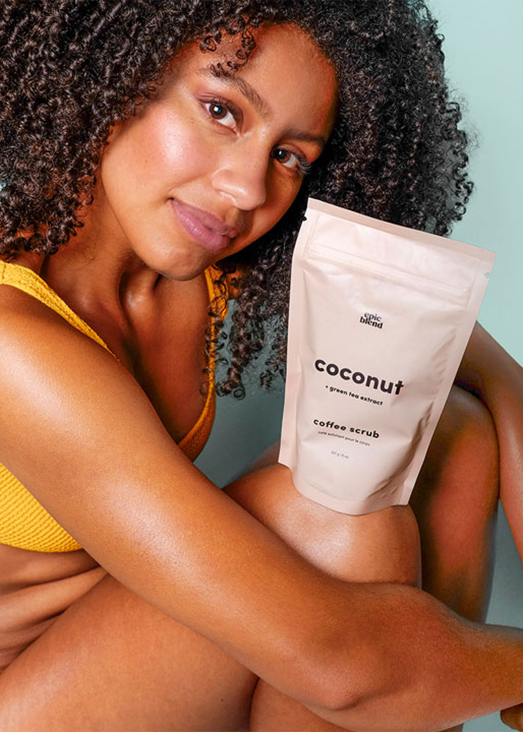 Still life of oranges, limes and avocados against a green backdrop.