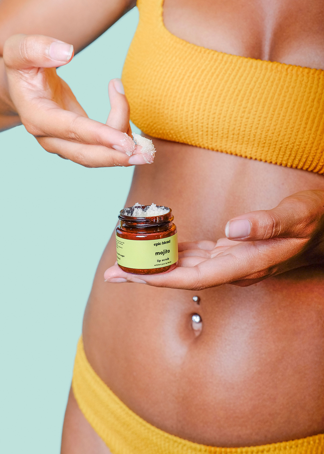 Still life of oranges, limes and avocados against a green backdrop.