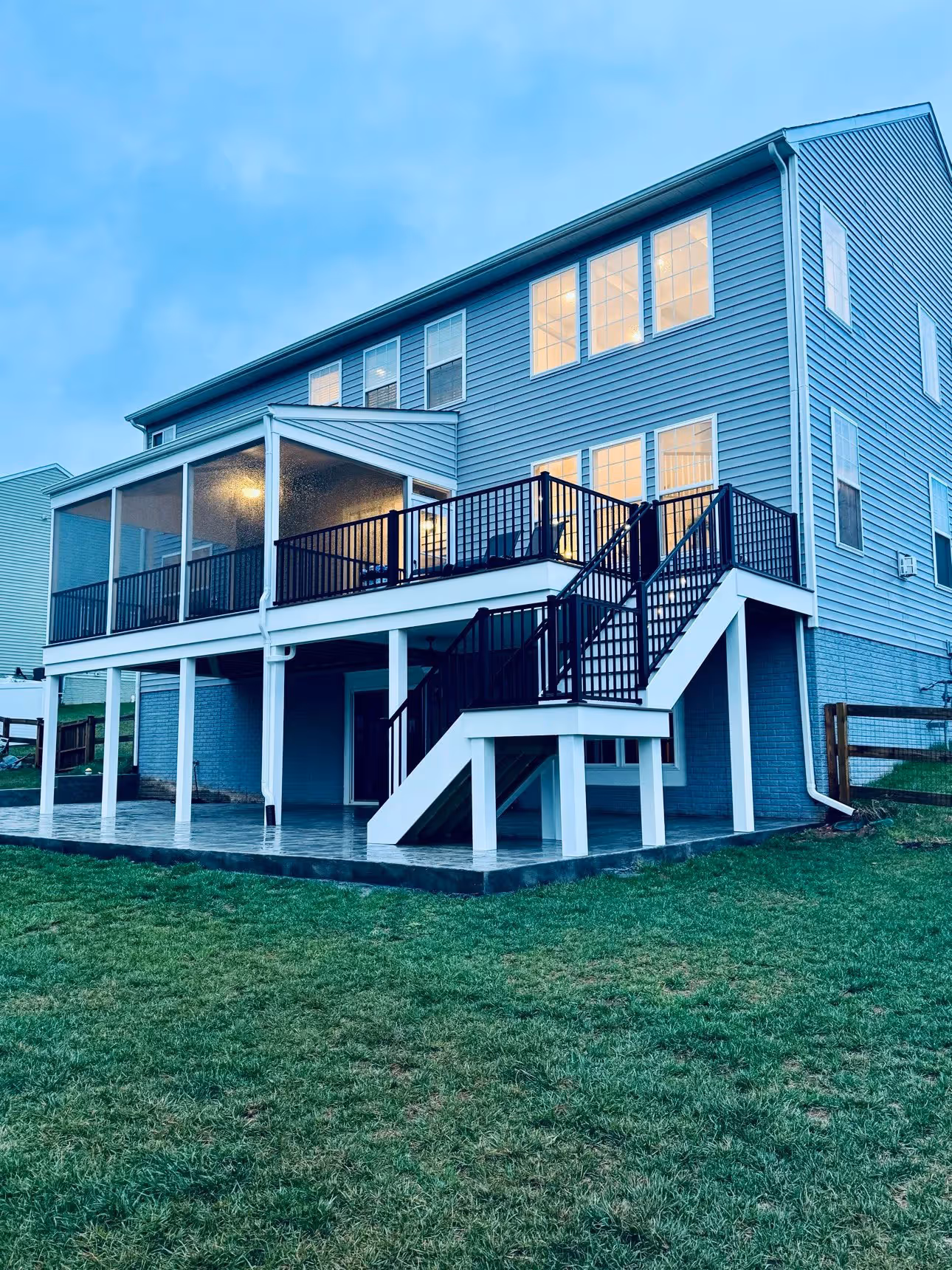 A porch installed by Arca Construction for a home in Stafford with stairs leading up to it.