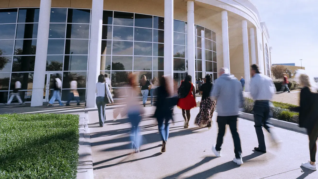 A modern church with many visitors entering the building