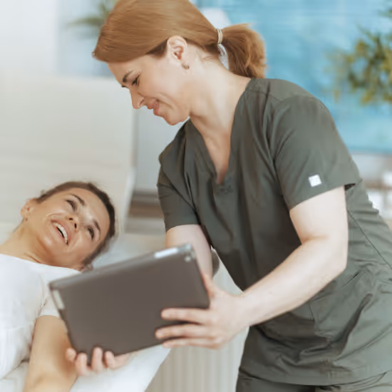 wellness practitioner smiling using practice management software with patient